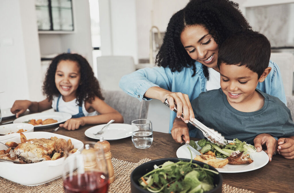 Mother and children eating a meal together, dry mouth and saliva oral health